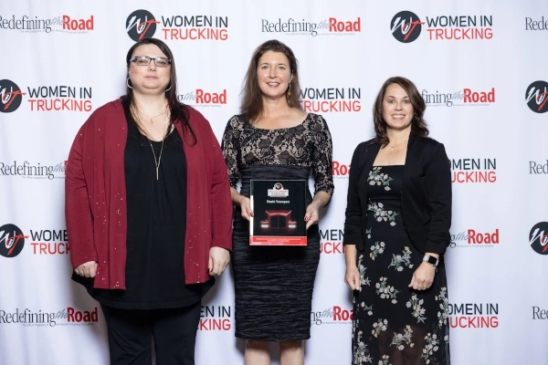 Susan B., Jennifer Hedrick & Stacey S. receiving 2024 Women in Trucking Top Companies For Women to Work For In Transportation Award