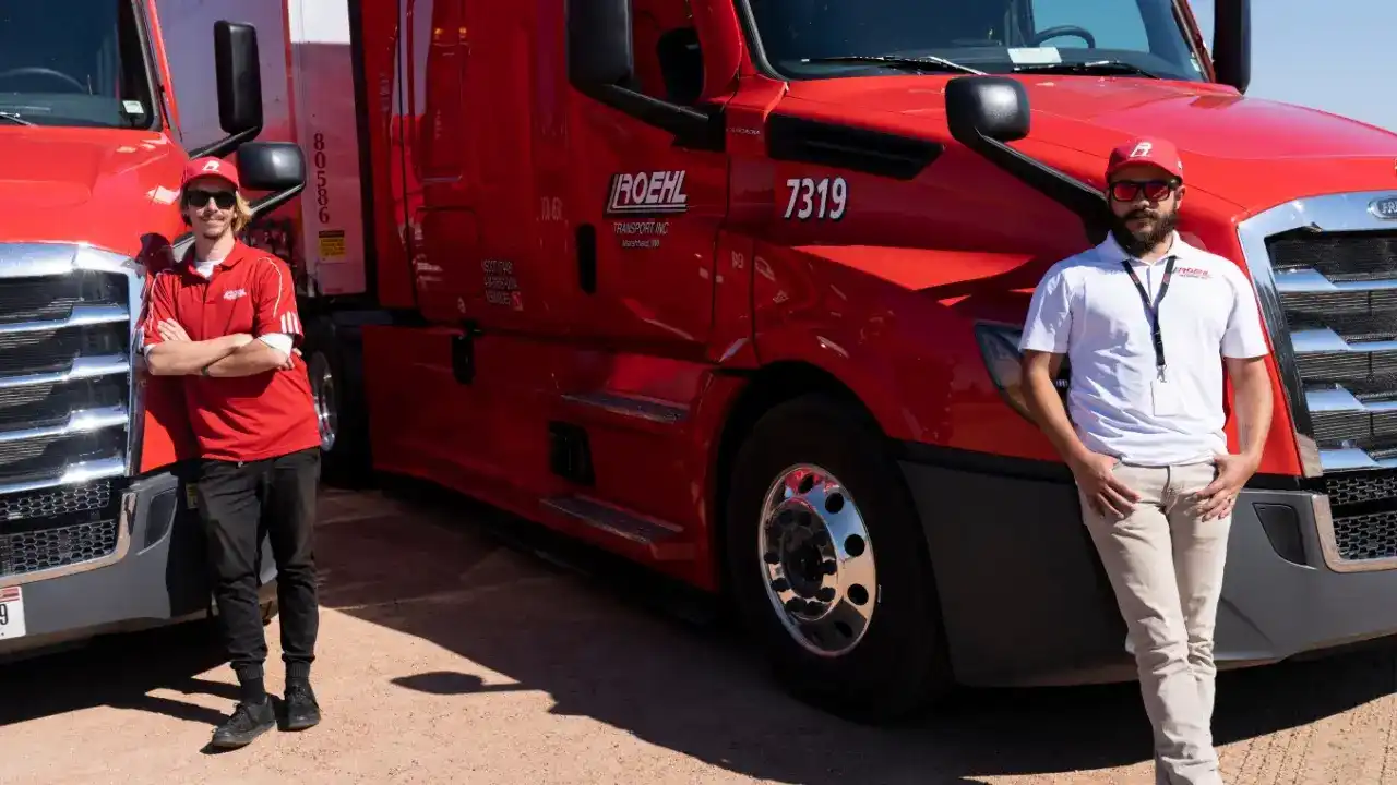 Student Drivers leaning on trucks