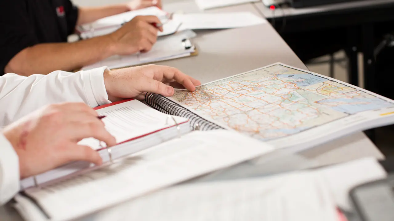 student studying map book