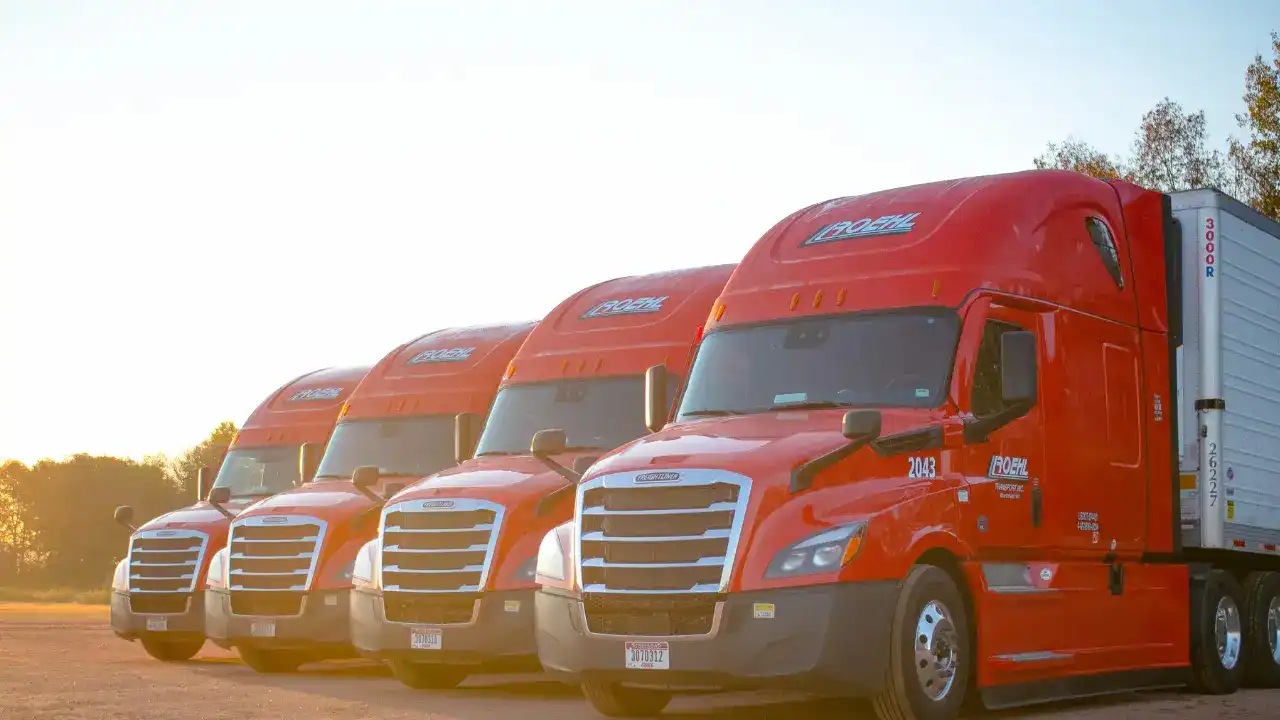 Line up of 4 Roehl trucks in daylight