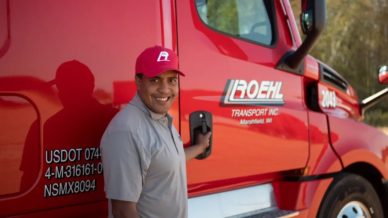 Roehl driver holding truck door