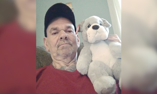 Gary W. with the stuffed animal Jesse, his fleet manager, sent him