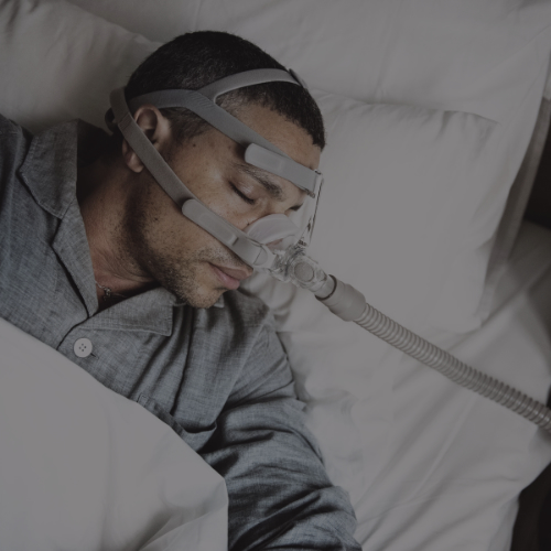 man sleeping with cpap machine on his face